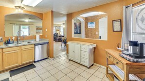 A kitchen with a dishwasher, a coffee machine, and a cabinet. - 4 Mi to Old Town: Pet-friendly Home w/ Fenced Yard (Albuquerque)