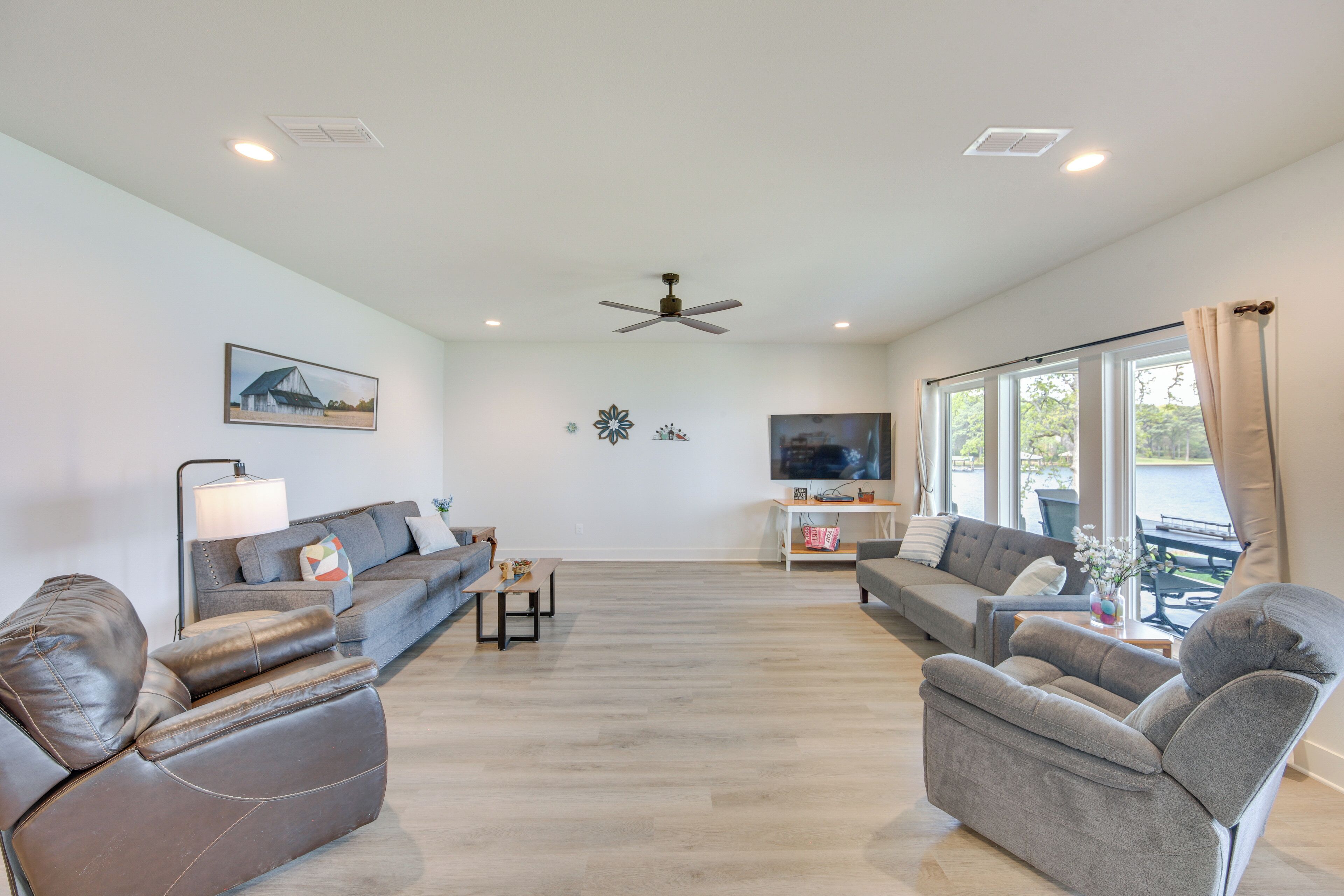 A modern living room with two sofas, a coffee table, and a TV.