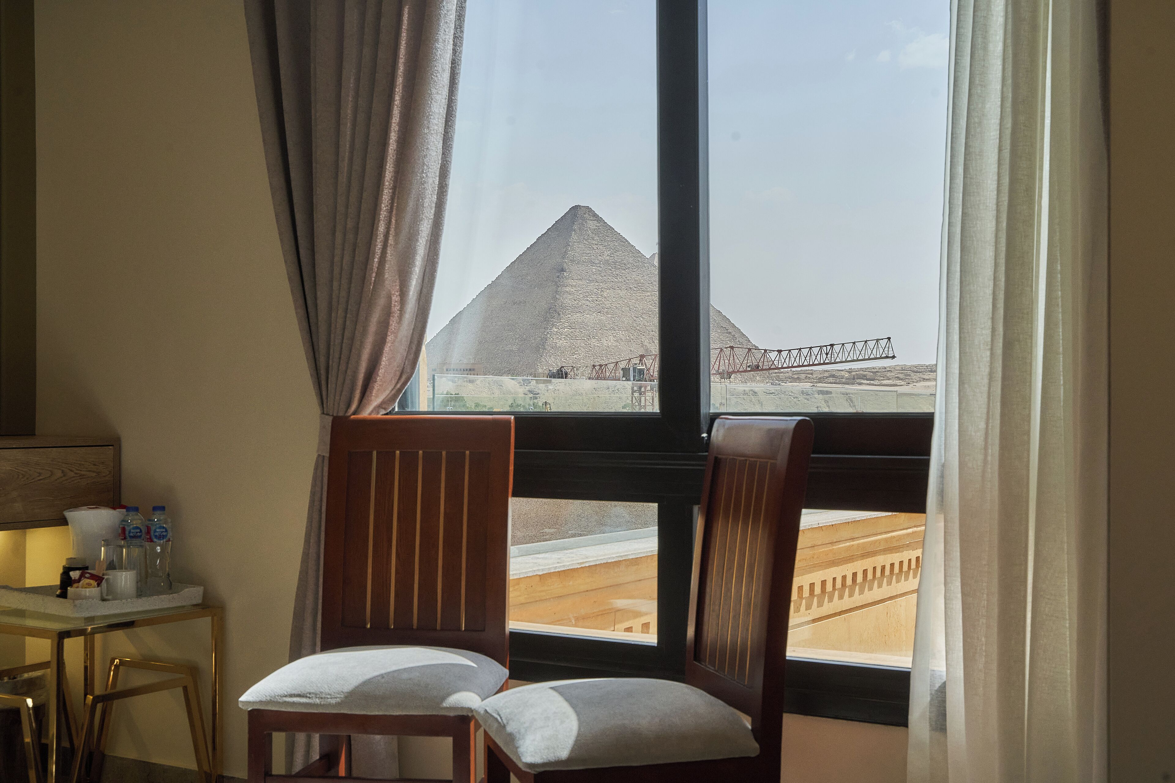 A hotel room with a view of the pyramid.