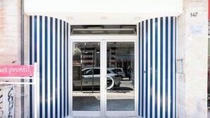 A building entrance with a glass door and striped walls. - Saint Nicholas House by Wonderful Italy (Bari)