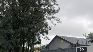 A gated entrance with a brick pathway leading to a building. - Comfortable Open-Plan Studio Stay — 36 On Blougom, Midrand (Midrand)