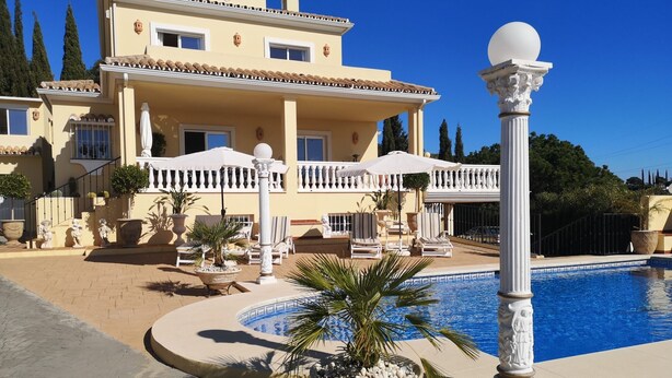A large building with a swimming pool, outdoor seating, and a decorative fountain. - Apartment 'Villa Roca' with Sea View, no kids under 10 year. (Málaga)