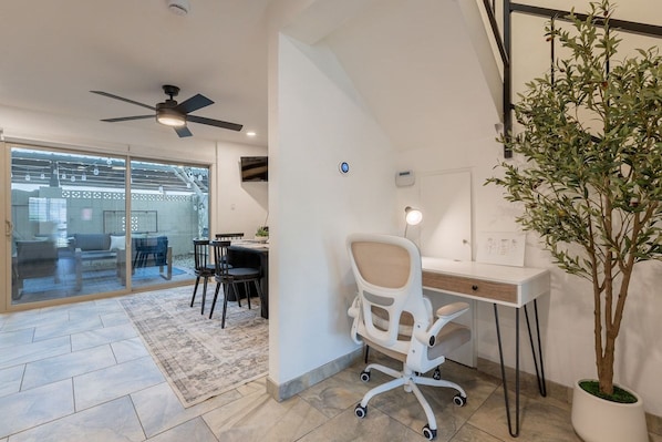 A modern office space with a desk, office chair, and a potted plant. - Old Town Living • Walk to Dining, Bars & Fun (Scottsdale)
