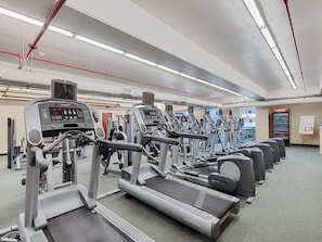 A gym with treadmills, ellipticals, and weight machines.