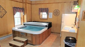 A wooden room with a hot tub, a sink, and a trash bin. - TM-2  Cox Retreat Amazing 6-Bedroom Hot Tub (Beech Mountain)