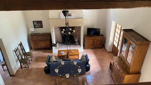 A spacious living room with a fireplace, a television, and a dining area. - House 160 m2 on 6000 m2, sleeps 12 Private garden + shared swimming pool (Espinas)