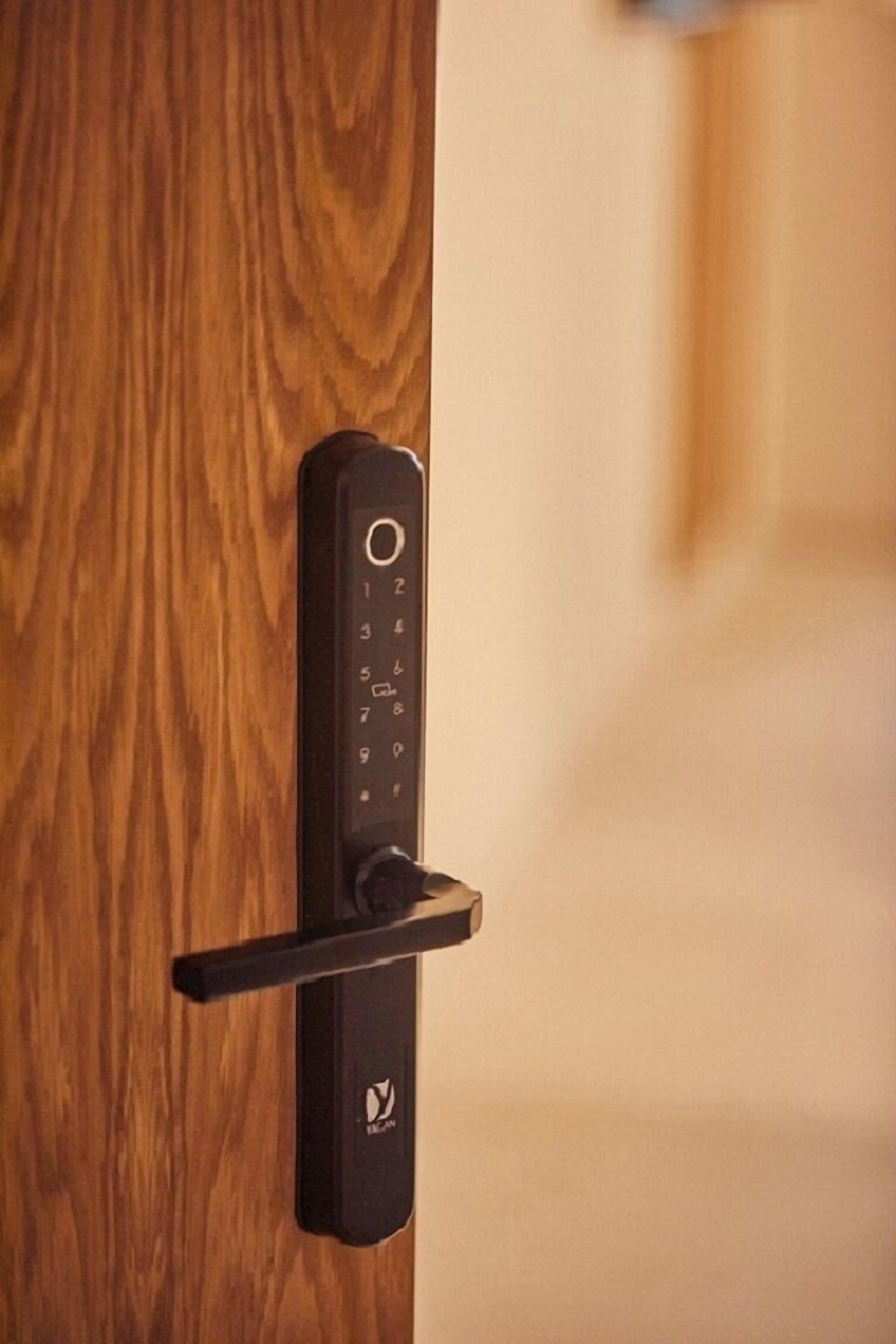 A modern door with a keypad lock and a lever handle.