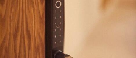 A modern door with a keypad lock and a lever handle.
