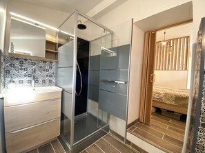 Shower, hair dryer, towels, toilet paper