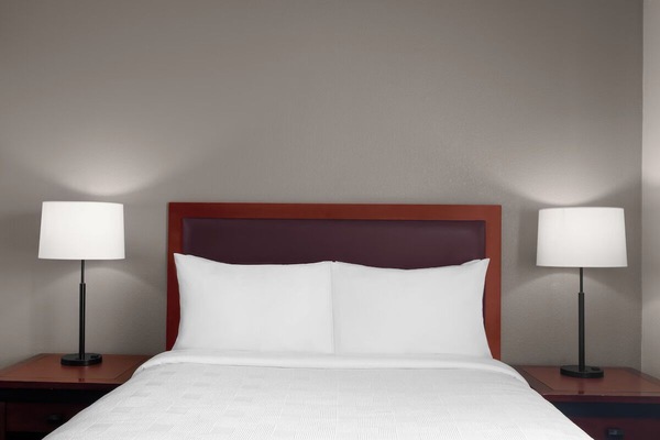 Unwind into crisp linens and soft bedside lighting.