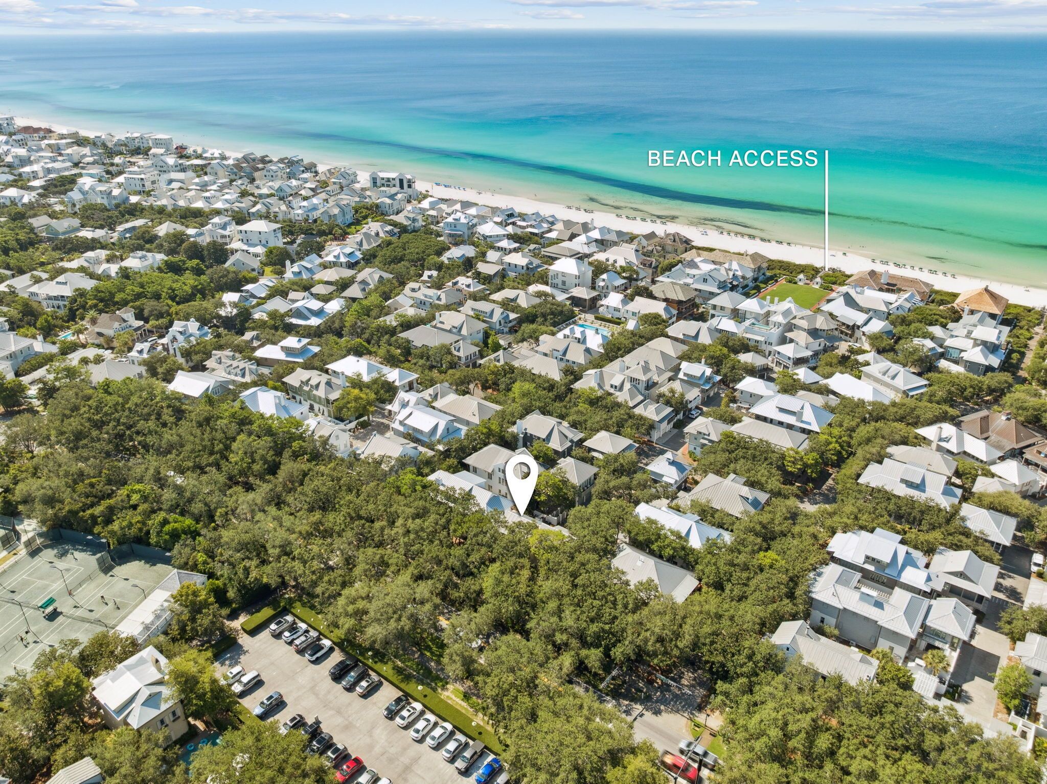An aerial view of a residential area with a beach access point marked.