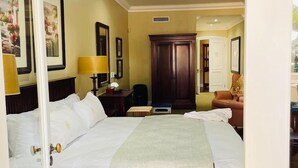 A hotel room with two beds, a desk, a chair, and a wardrobe. - Presidential Boutique Hotel (Durban North)