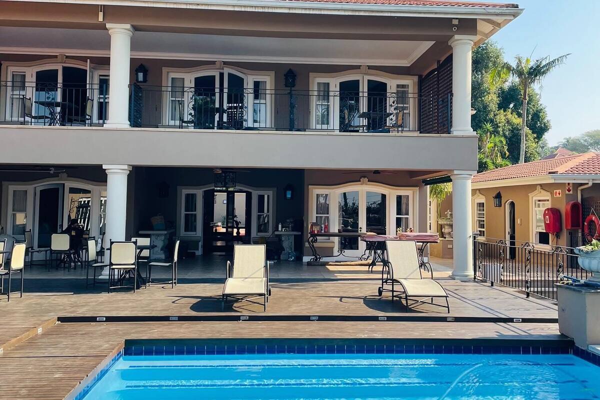 A two-story building with a swimming pool in front.