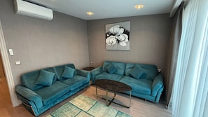 Elite Suite, City View | Living area | 75-inch Smart TV with satellite channels