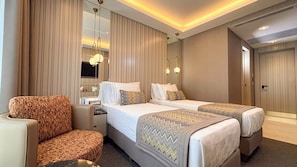 A hotel room with two beds, a sofa, a desk, and a mirror. - Saygın Beşiktaş (Istanbul)