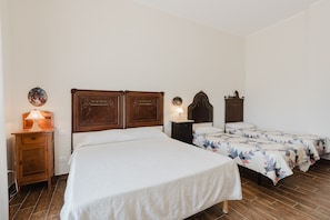 A bedroom with a large bed, two bedside tables, and a nightstand.