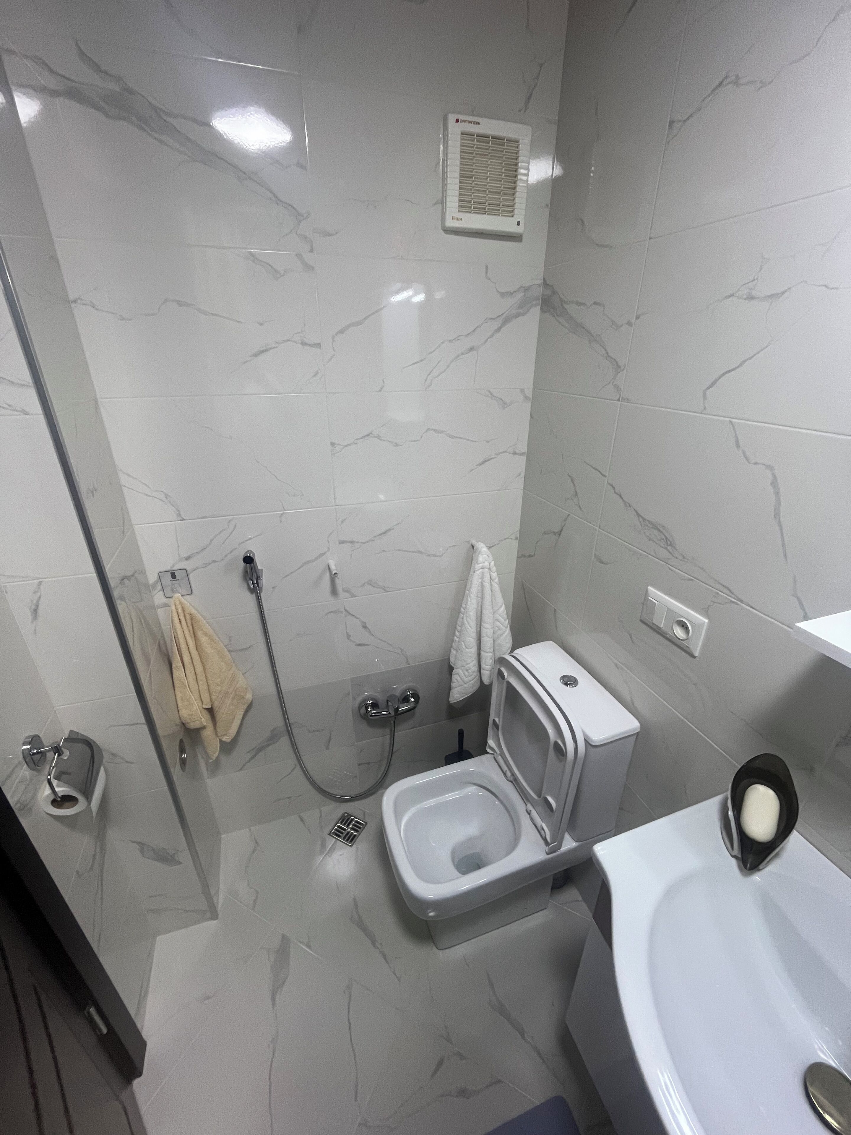 Shower, hair dryer, towels, toilet paper