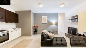 A modern apartment with a kitchen, dining area, and living room. - Spacious, comfortable 2BR home in Msida with WIFI (L-Imsida)
