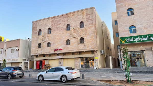 A building with multiple storefronts, including a pharmacy and a restaurant.