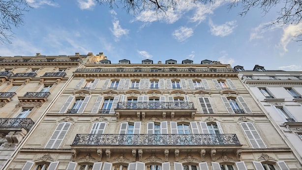 A multi-story building with ornate balconies and shutters. - Stunning AC Duplex Apartment - Champs Elysees (Paris)