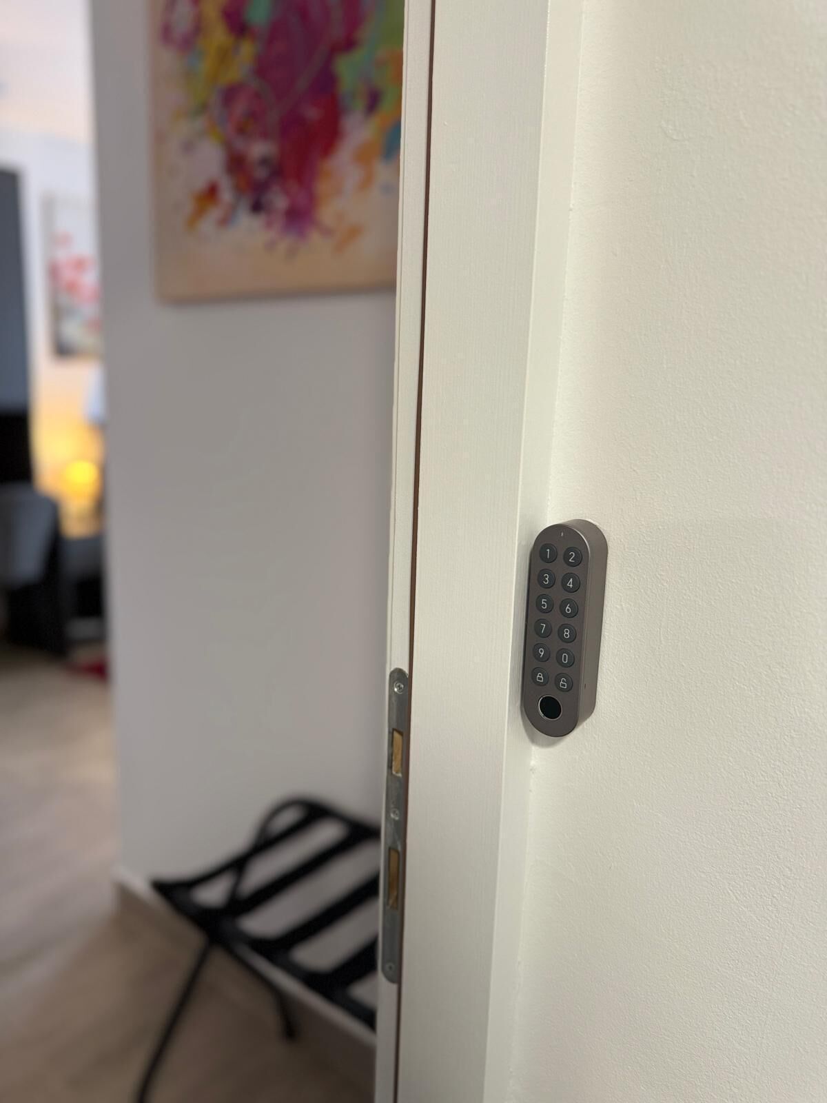 A door with a keypad lock and a small window.
