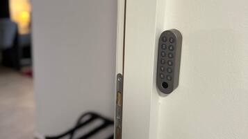 A door with a keypad lock and a small window.
