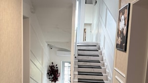 A staircase with white walls and a marble floor leading to an upper level. - Alsago Lux (Sesvete)