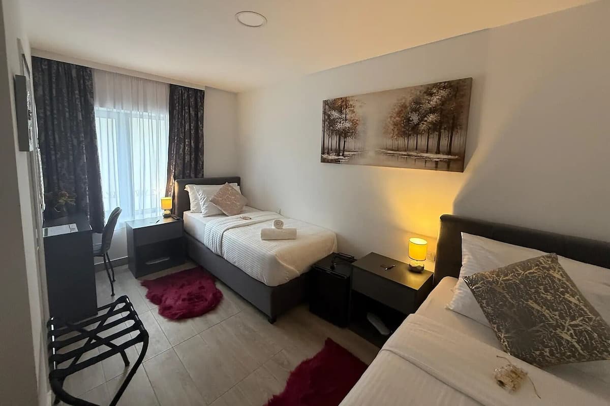 Twin Room, Garden View | Minibar (free items), in-room safe, blackout drapes, WiFi (free)