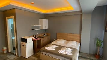 Standaard kamer, kitchenette | Lakens van Egyptisch katoen, luxe beddengoed, een bureau, gratis wifi