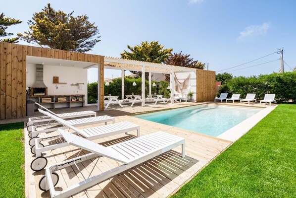 Outdoor pool, open 9:00 AM to 8:00 PM, pool loungers