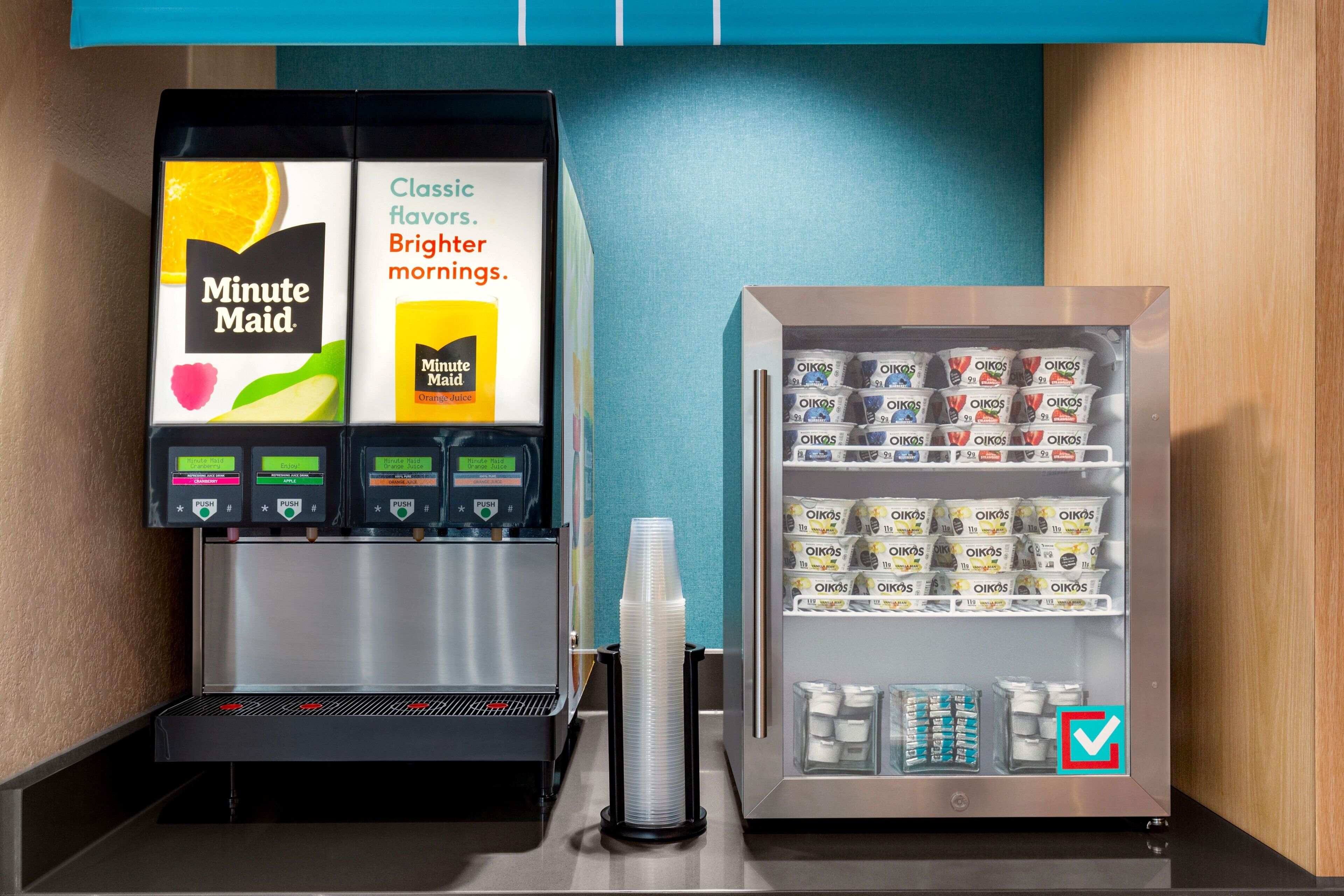 A coffee machine and a refrigerated display with various packaged goods.