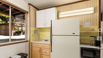 Fridge, microwave, coffee/tea maker, cookware/dishes/utensils
