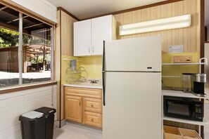 Fridge, microwave, coffee/tea maker, cookware/dishes/utensils
