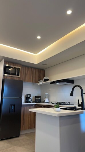 Fridge, microwave, stovetop, coffee/tea maker