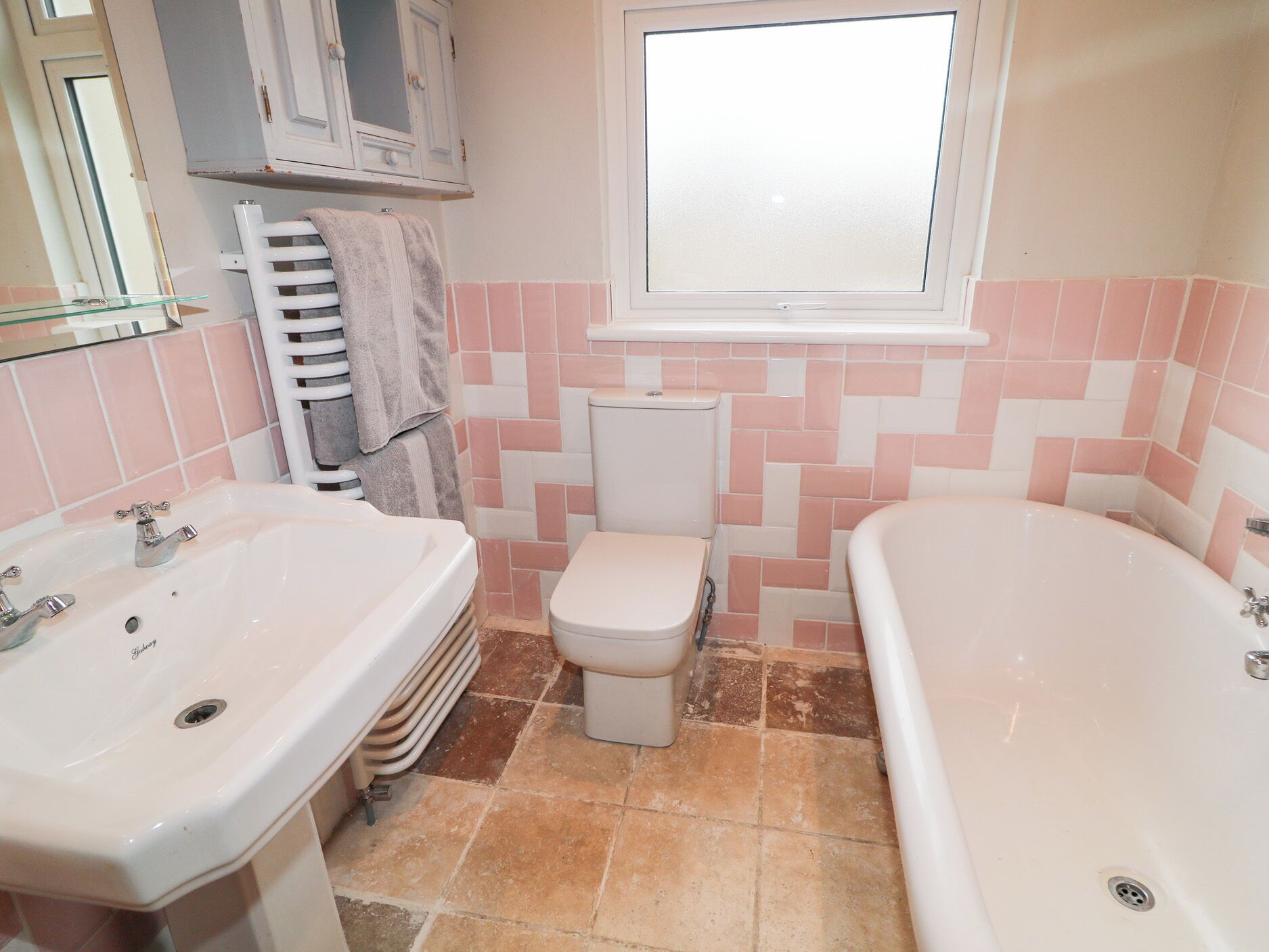 A bathroom with a sink, toilet, and bathtub.