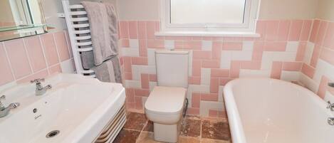 A bathroom with a sink, toilet, and bathtub.