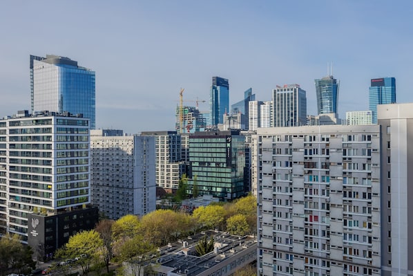 A cityscape with modern high-rise buildings, including a distinctive curved skyscraper and several rectangular structures.