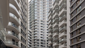 A modern high-rise building with multiple balconies and large windows.