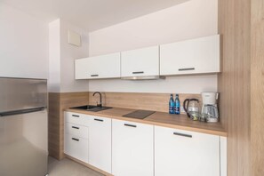 Fridge, stovetop, dishwasher, coffee/tea maker