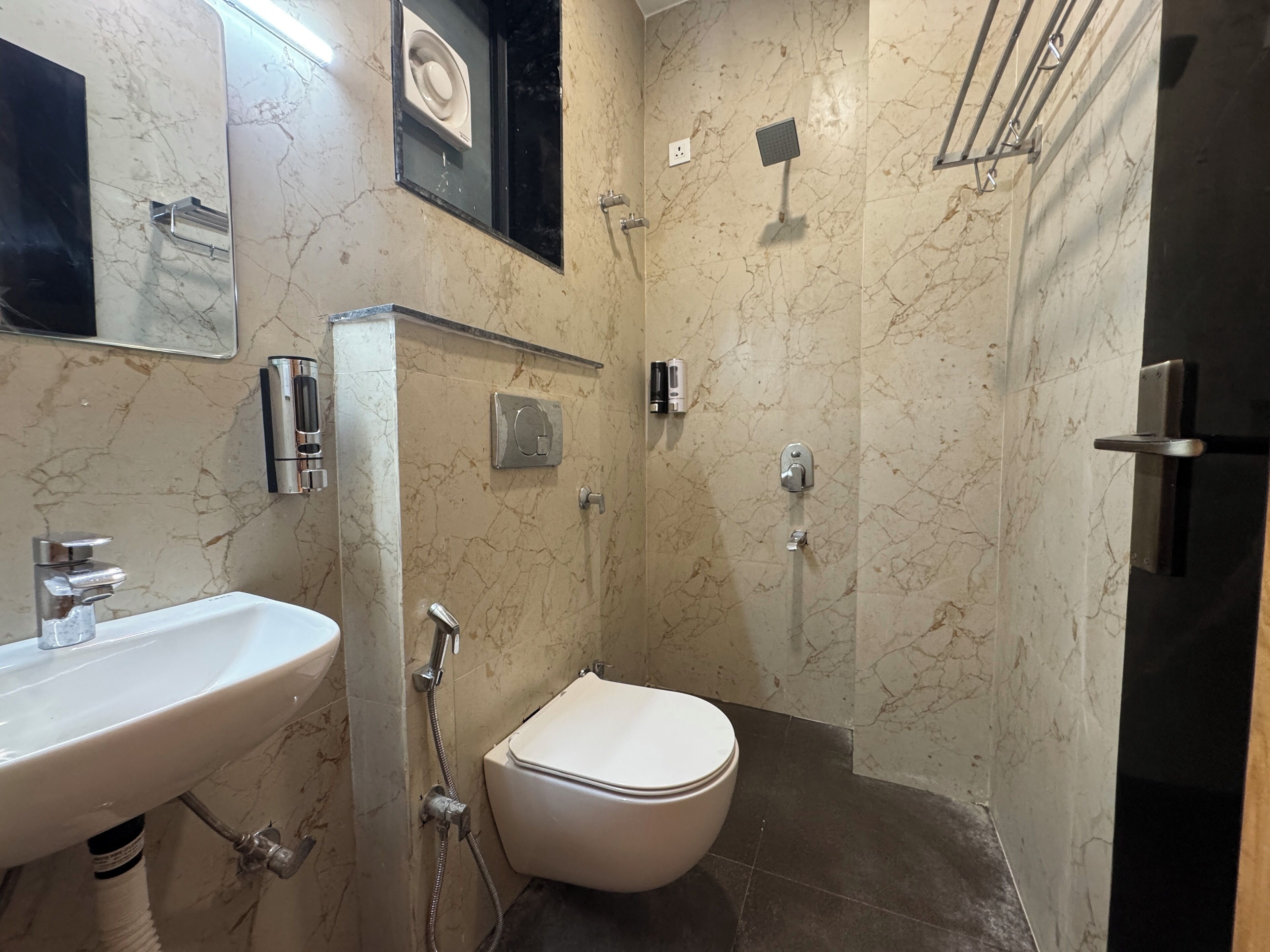A bathroom with a sink, toilet, and shower.