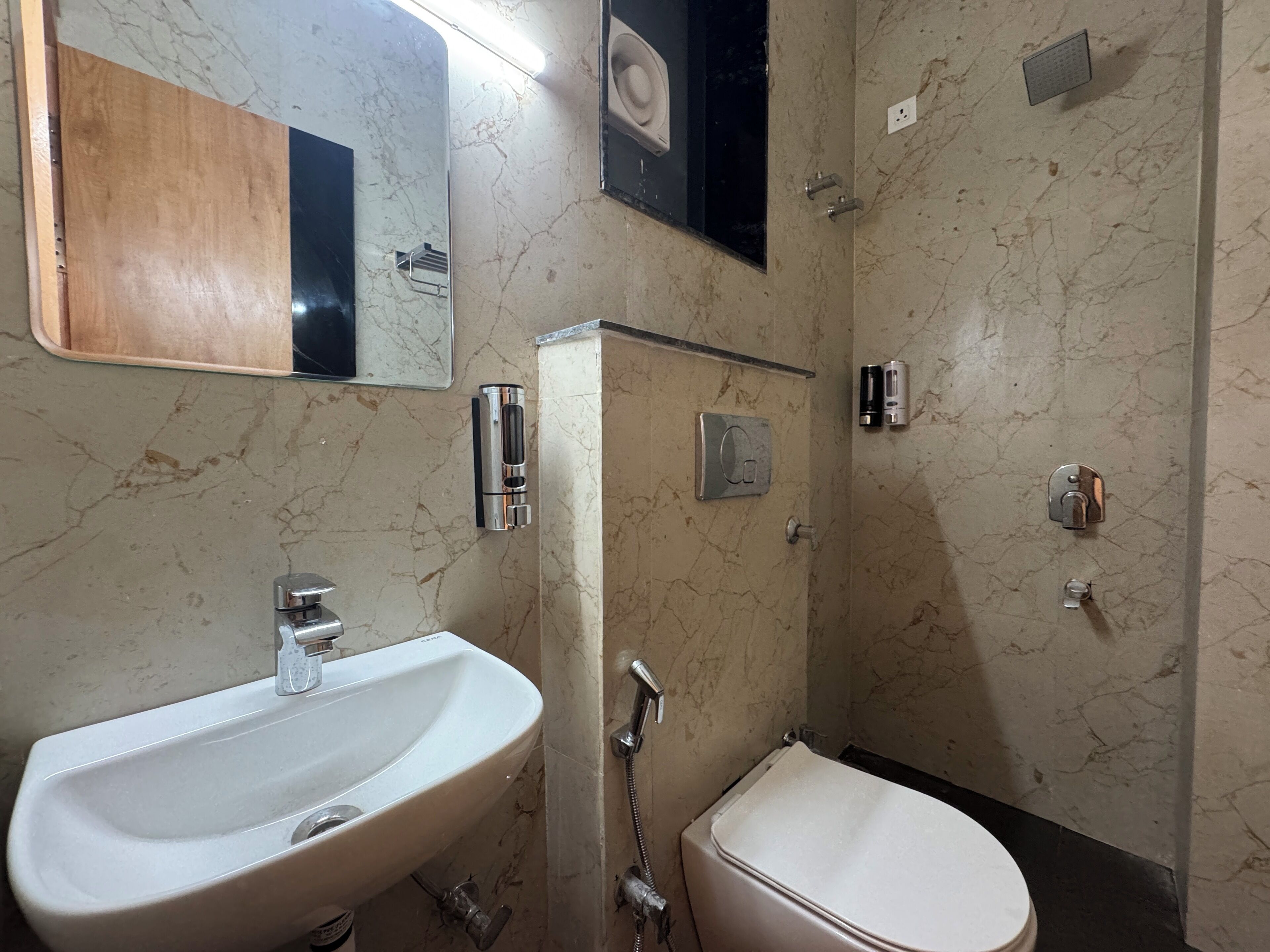 A bathroom with a sink, toilet, and shower.
