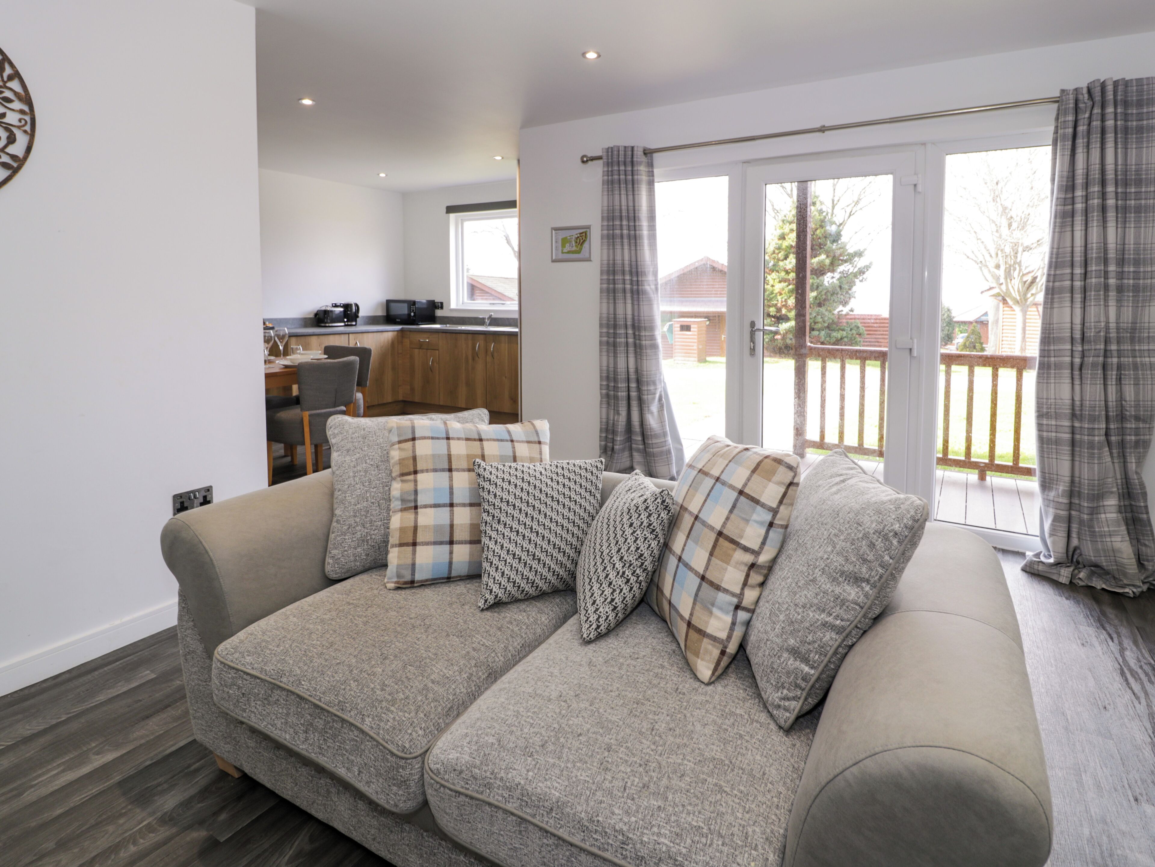 A cozy living room with a sofa, a dining area, and a kitchen.
