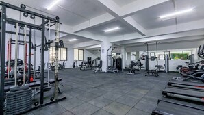 A spacious gym with various exercise equipment, including treadmills, weight machines, and free weights. - Spacious,New Apartment with WiFi,Gym and heated pool in Lavington, Nairobi (Nairobi)