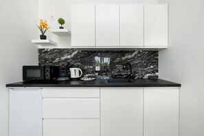 Réfrigérateur, four à micro-ondes, surface de cuisson, cafetière-théière