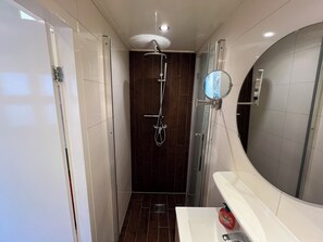 Shower, hair dryer, towels, toilet paper