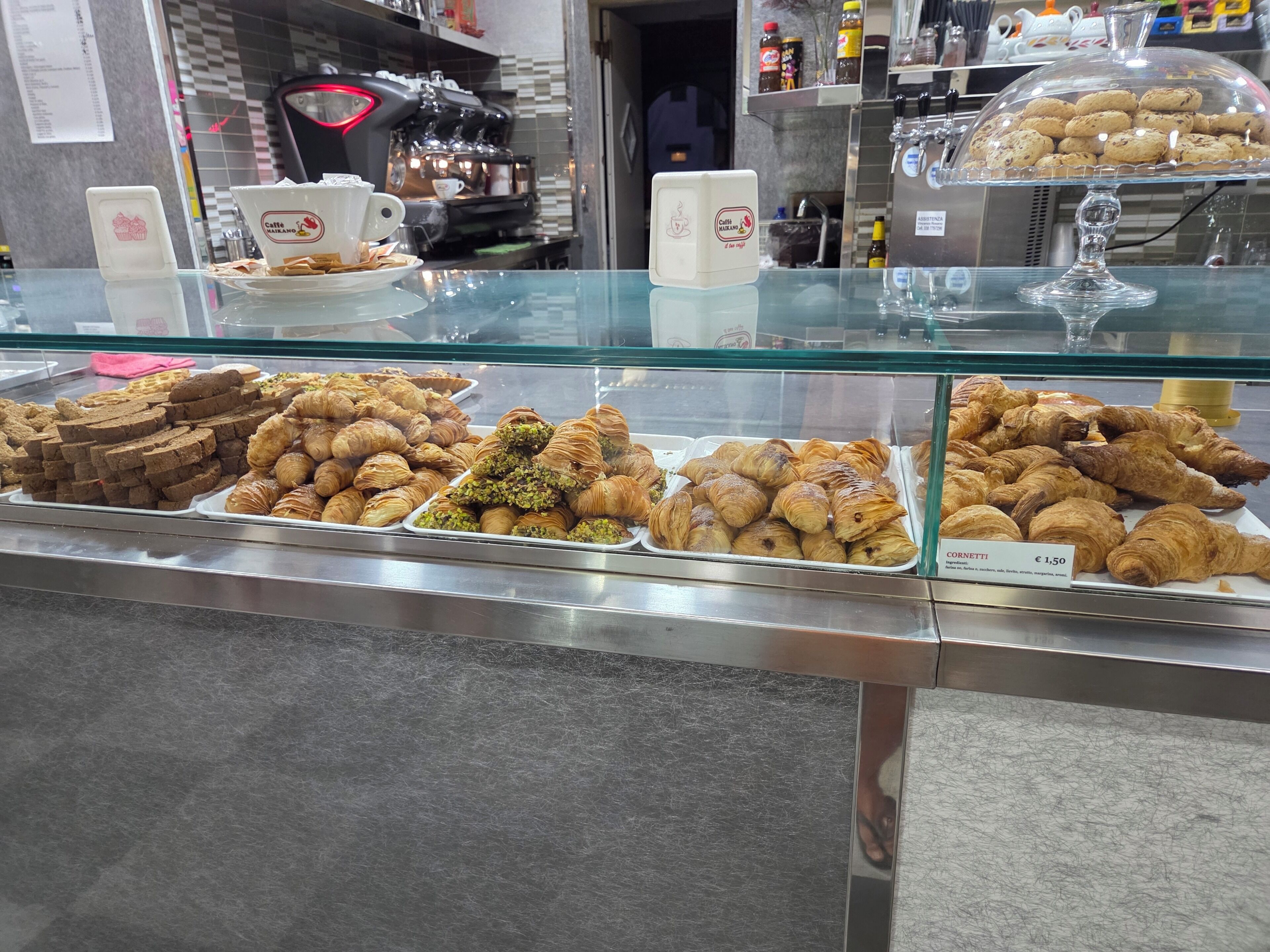 A bakery display with various baked goods.