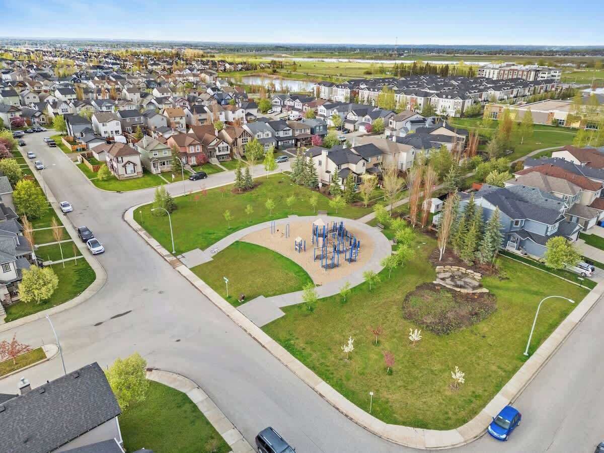 A residential area with houses, a playground, and a road.