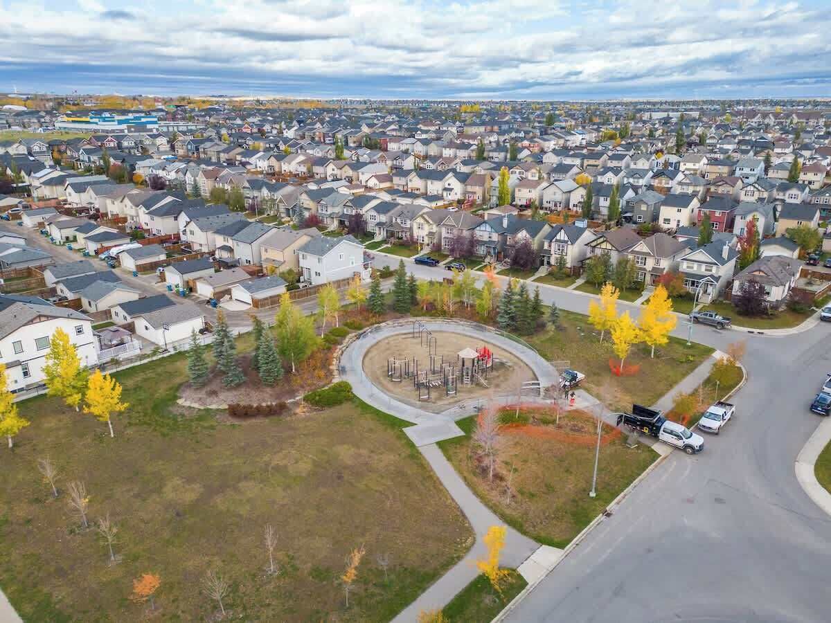 A residential area with houses, a playground, and a road.