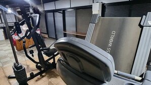 A gym with exercise equipment, including a treadmill and an elliptical machine.