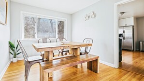 A modern kitchen with a stainless steel refrigerator and wooden flooring. - Homewood Oasis with 3 Beds and A Fully Fenced Backyard! (Homewood)